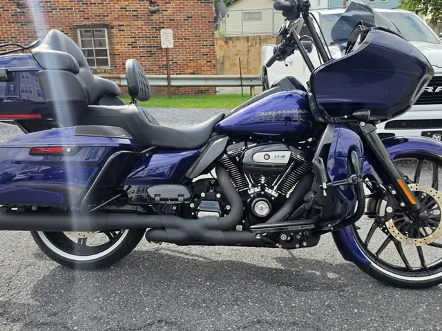 Side view of a blue Harley-Davidson Road Glide on the carrier, front wheel in the chock